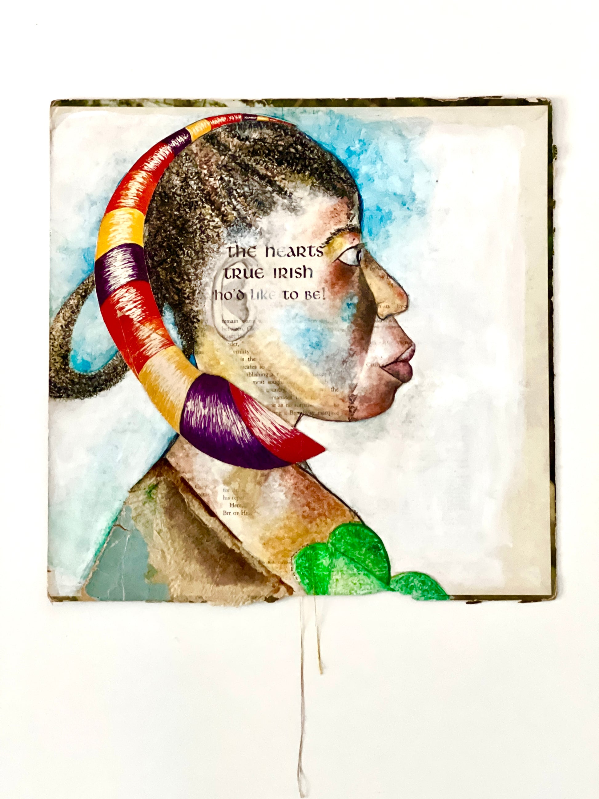 A mixed media artwork featuring a stylized portrait of a woman with an elaborate hairstyle, incorporating elements of Irish and African American culture, unframed.